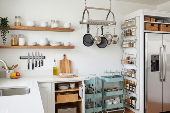 Small kitchen using wall shelves and open storage instead of extra cabinets.