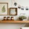 Travel keepsakes styled as home decor, including a framed pressed fern, shadow box, soy candles and a terrarium